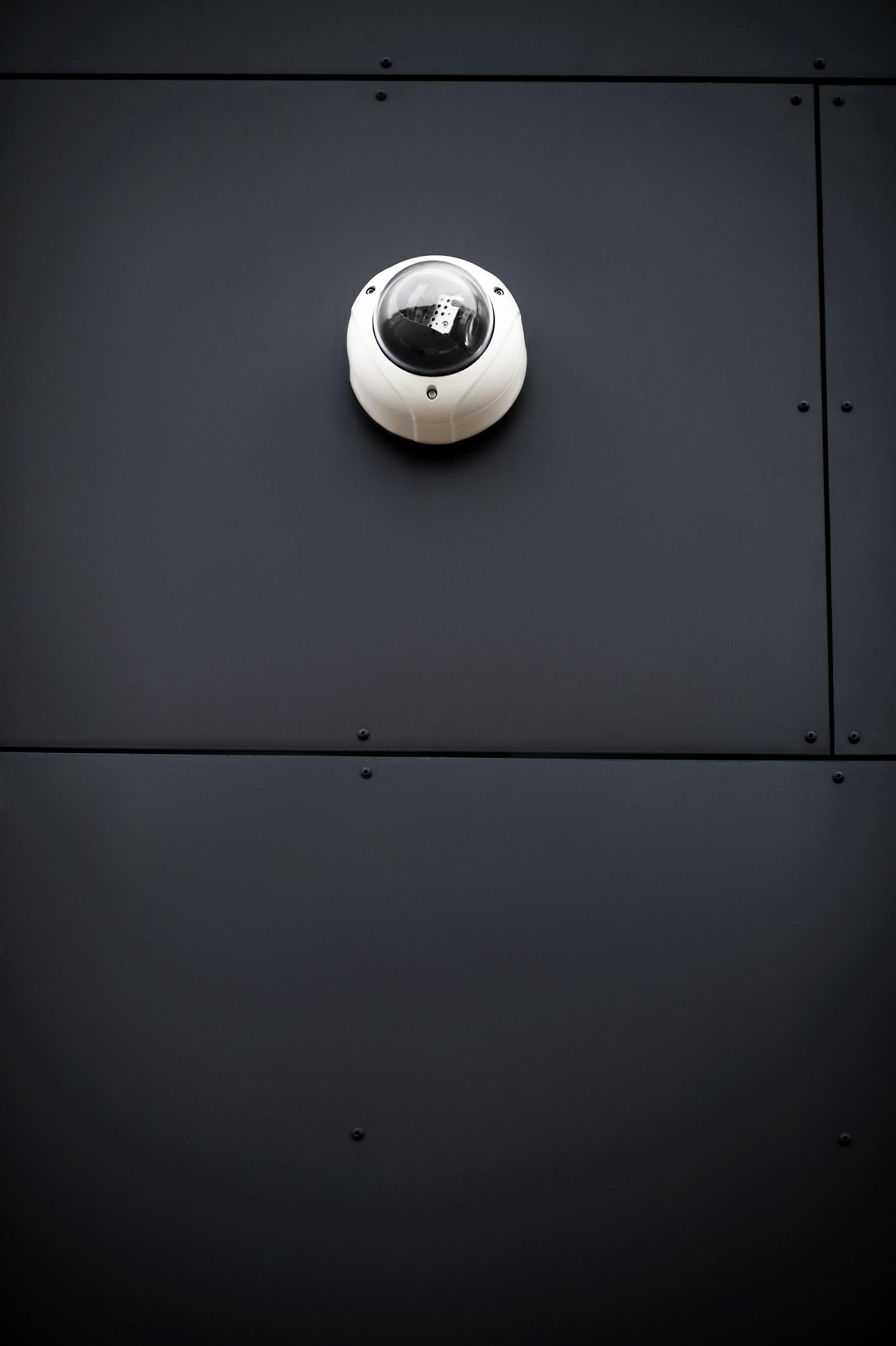 Surveillance concept - Security video camera on wall of building